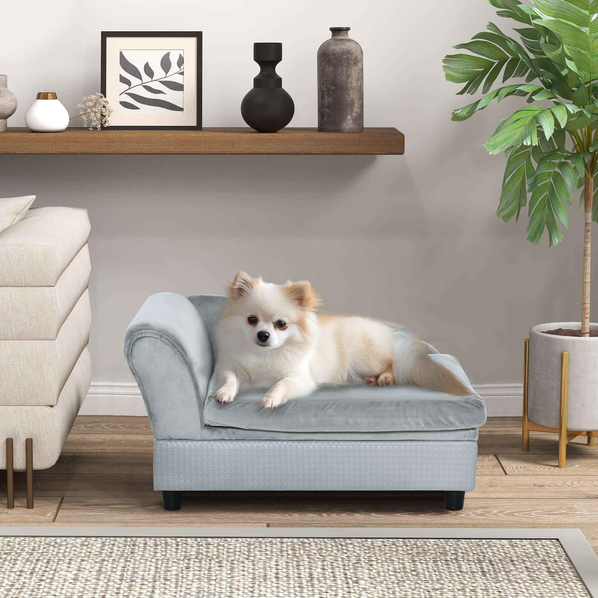Small dog lounging on a luxury gray foam couch dog bed with hidden storage, modern pet furniture.