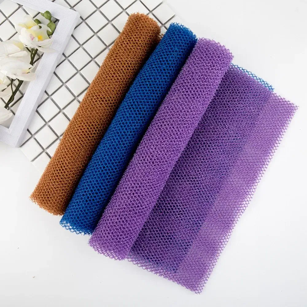 Colorful mesh African exfoliating sponges in brown, blue, and purple arranged neatly for smooth skin care.