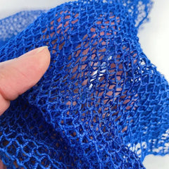 Close-up of a blue exfoliating mesh sponge showcasing its durable nylon texture for effective skin smoothing.